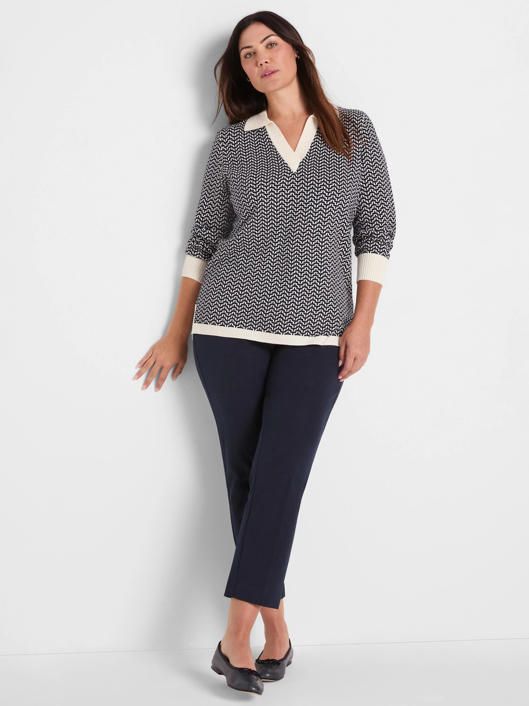 Two-tone navy and cream chevron jacquard sweater with a polo collar, 3/4 sleeves, and ribbed trim.