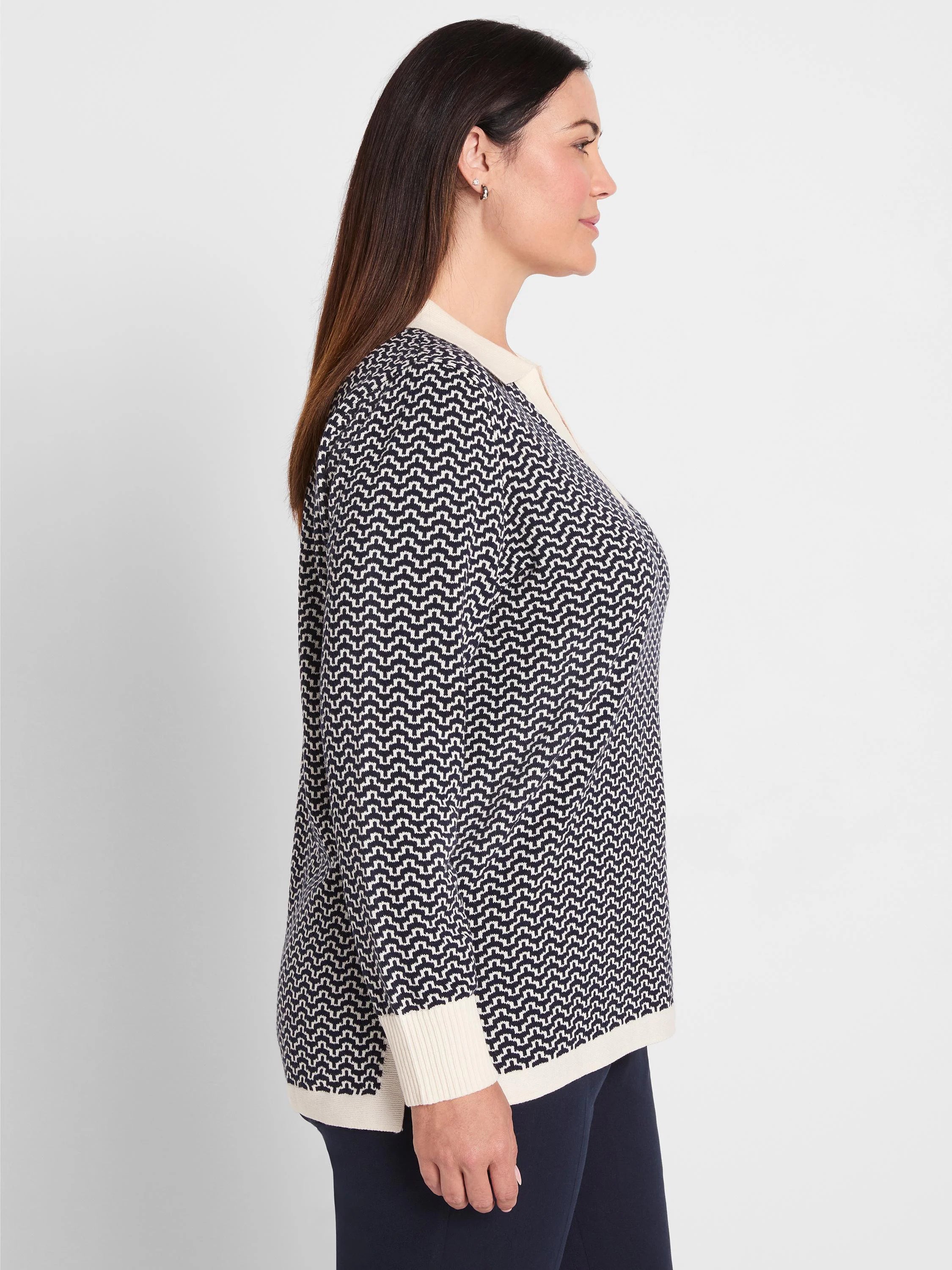 Navy and cream jacquard sweater with a zig-zag pattern, featuring a cream collar, ribbed cuffs, and hem.