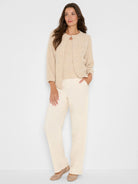 Light beige fuzzy Lurex nep cardigan with keyhole neck, 3/4 sleeves, and scattered rhinestones.