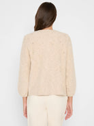 Beige fuzzy knit cardigan with subtle metallic flecks & nubs. Features scattered clear rhinestones on the upper back....
