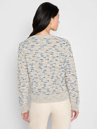 Cream sweater jacket with blue and tan textured knit, long sleeves, ribbed cuffs and hem.