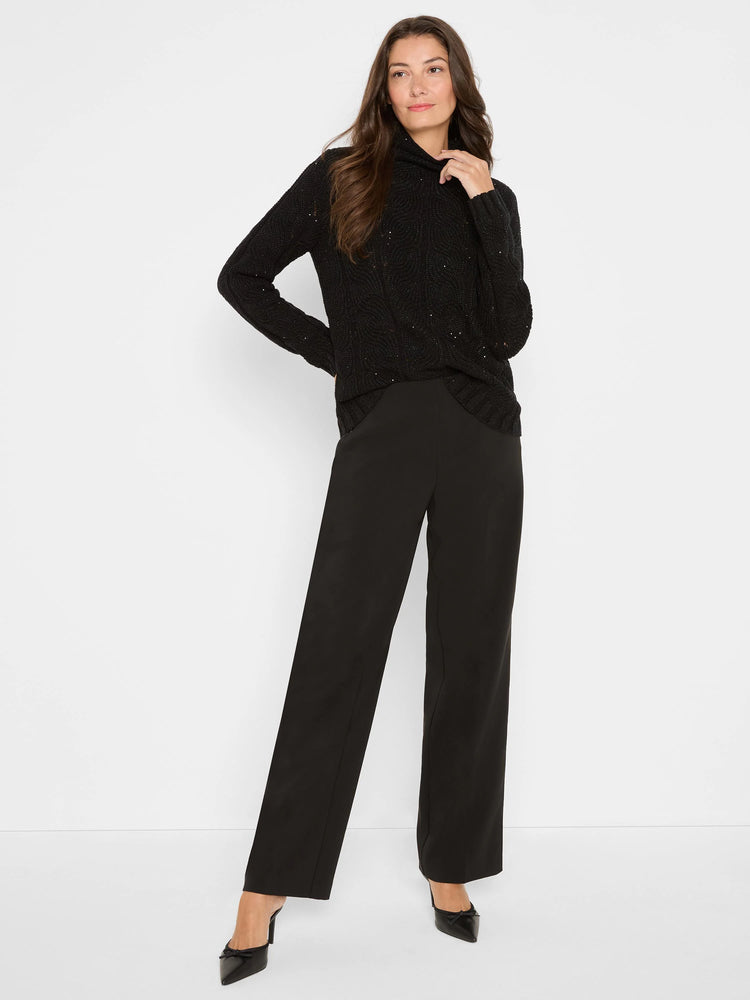 Black cable knit sweater with scattered sparkles and a high, ribbed collar.