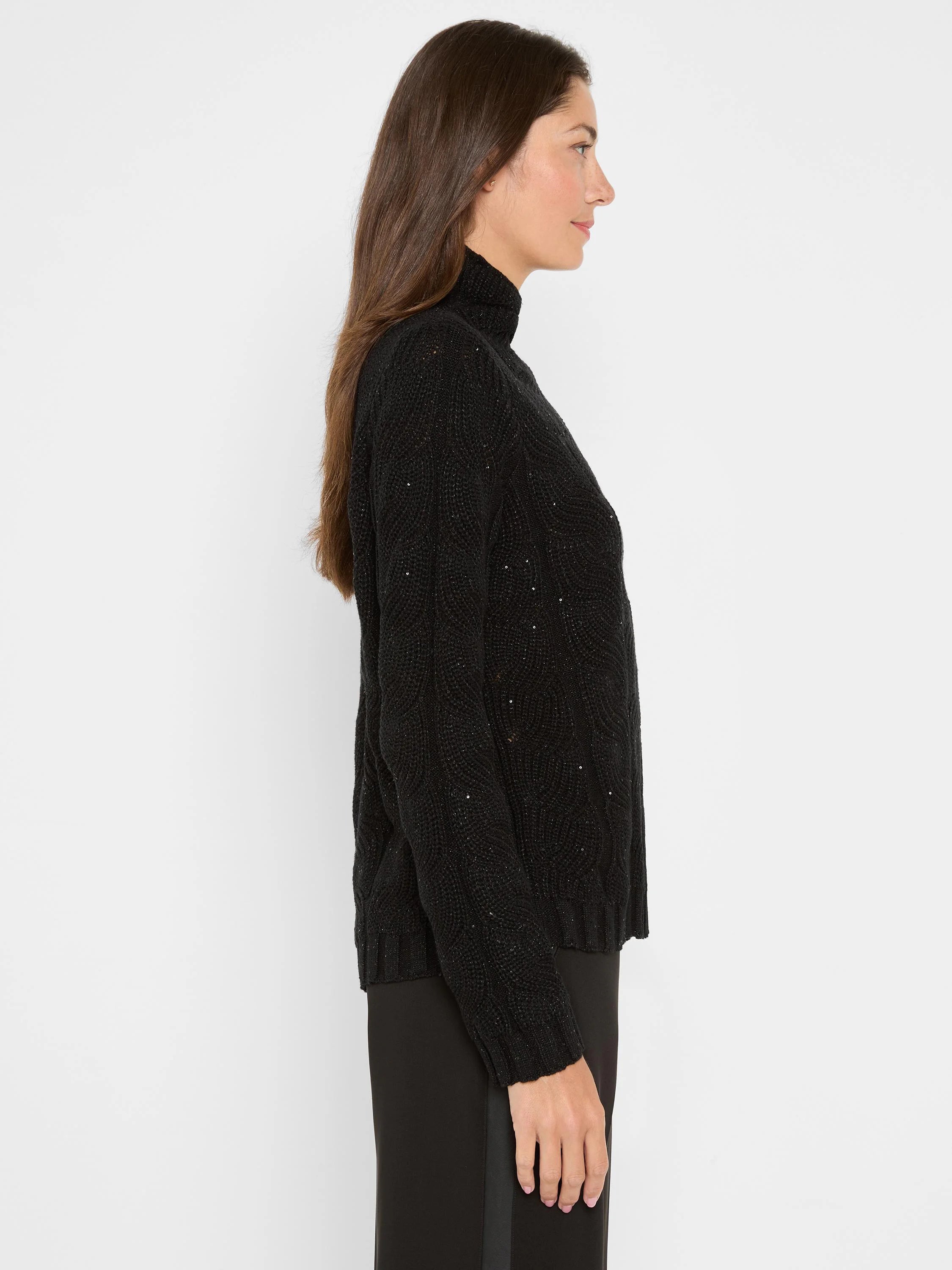 Black turtleneck sweater with textured cable knit and scattered shiny sequins.