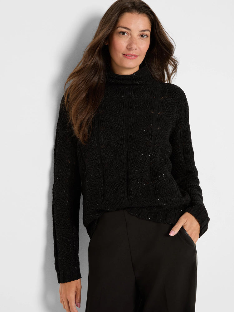 Black cable knit turtleneck sweater with scattered sparkles.