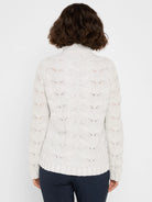 Back view of a light gray cable knit sweater with all-over sparkle, high neck, and ribbed hem.