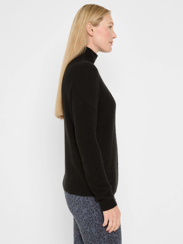 Black waffle tuck knit turtleneck sweater.