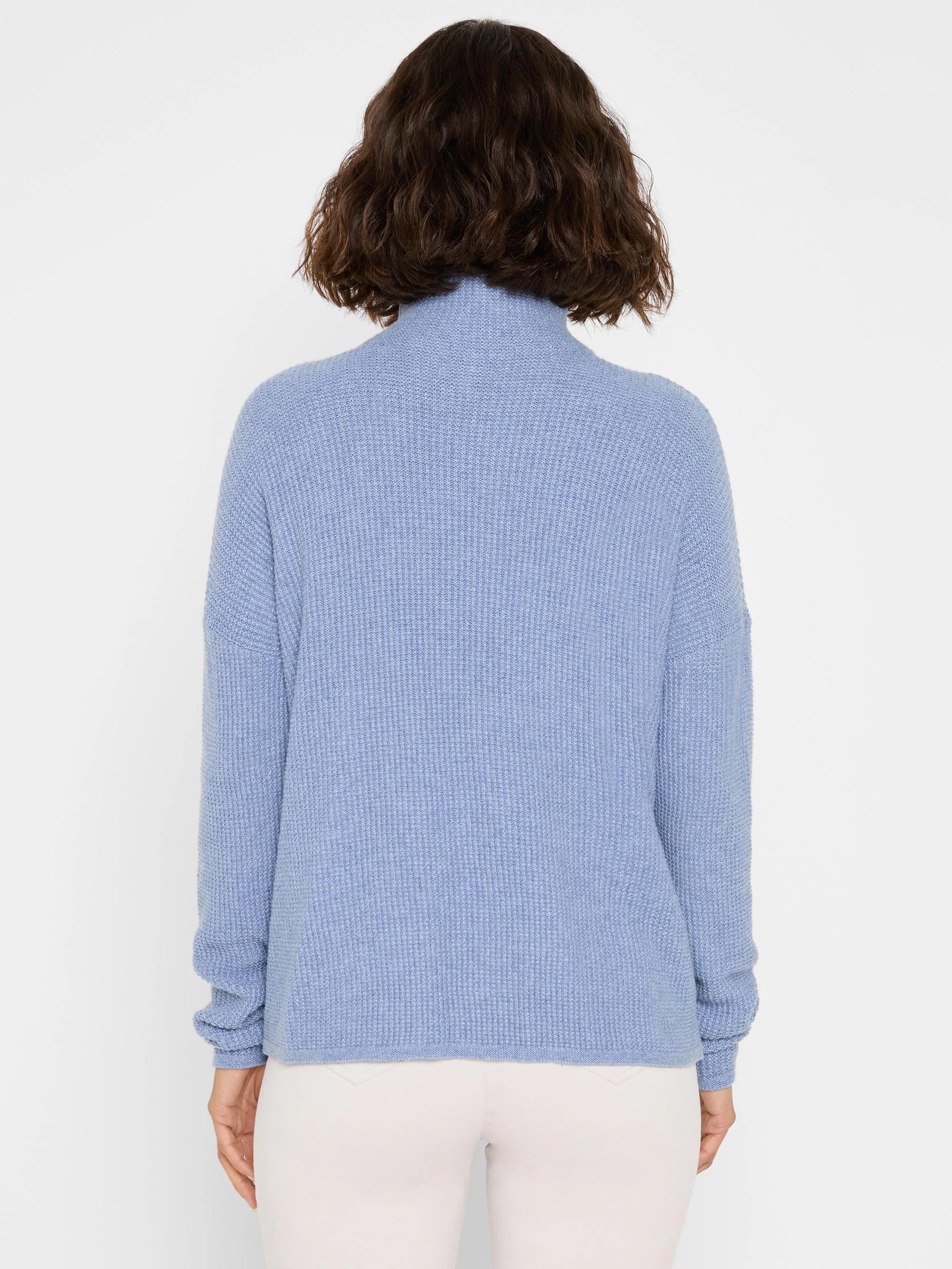 Periwinkle blue waffle knit sweater with a high neck and long sleeves, shown from the back.