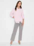 Light pink fuzzy sweater with horizontal rows of raised, wavy knit texture.
