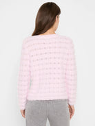 Light pink fuzzy sweater, back view, with alternating horizontal stripes of solid knit and open wavy pattern.