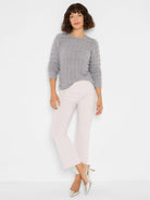 Light grey fuzzy sweater with horizontal rows of textured, wave-like knit patterns.