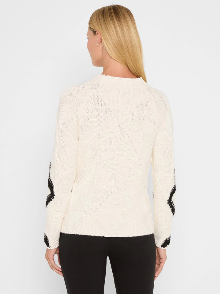 Cream knit sweater with diamond pattern. Black chevron design on outer long sleeves.