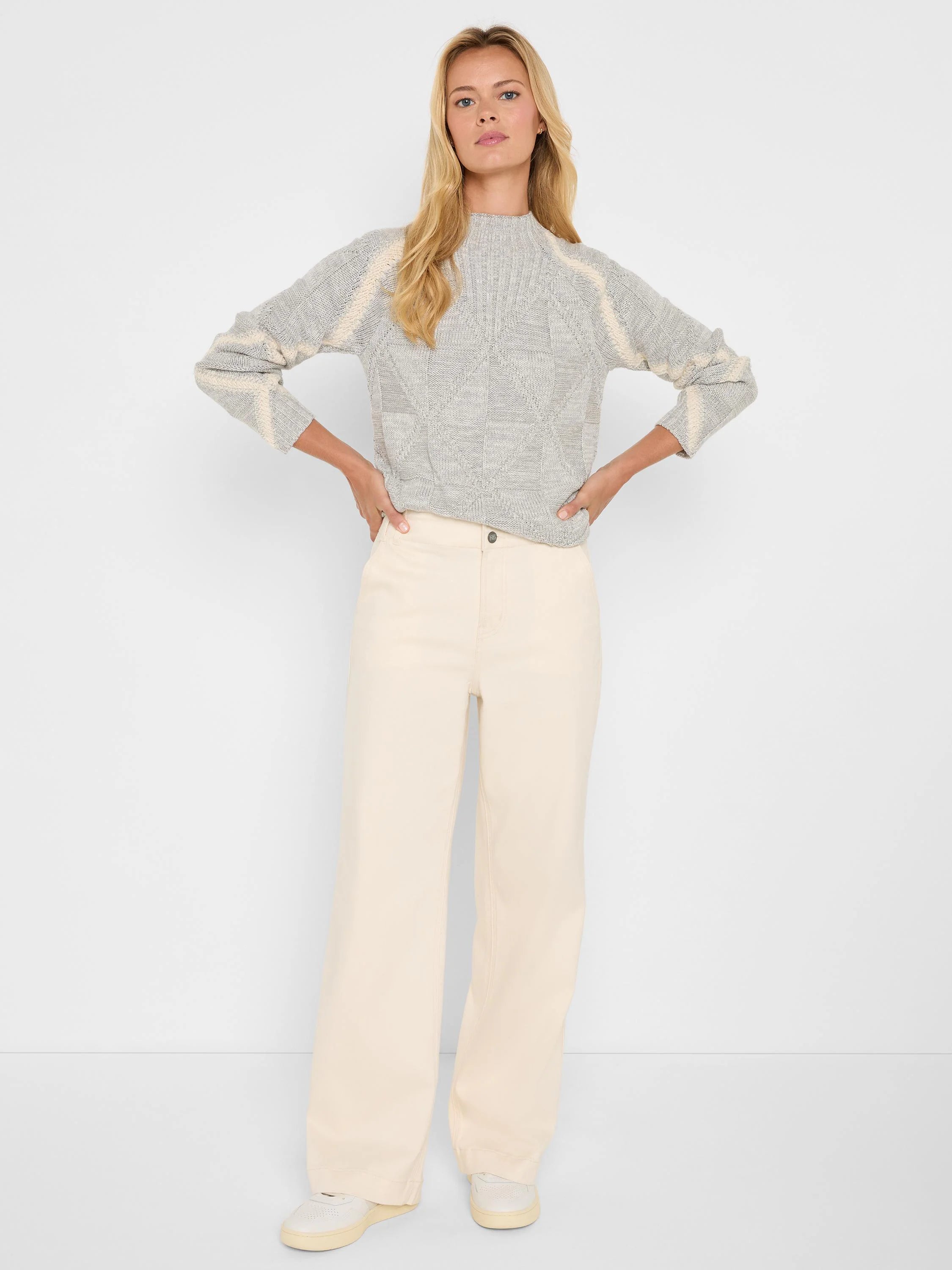 Grey knit mock neck sweater with cream diamond patterns on the body and cream stripes on the sleeves.