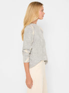 Light grey sweater with cream geometric diamond knit pattern, mock neck.