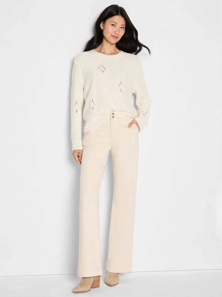 Cream long-sleeve sweater featuring an open-knit paisley dot pattern throughout.