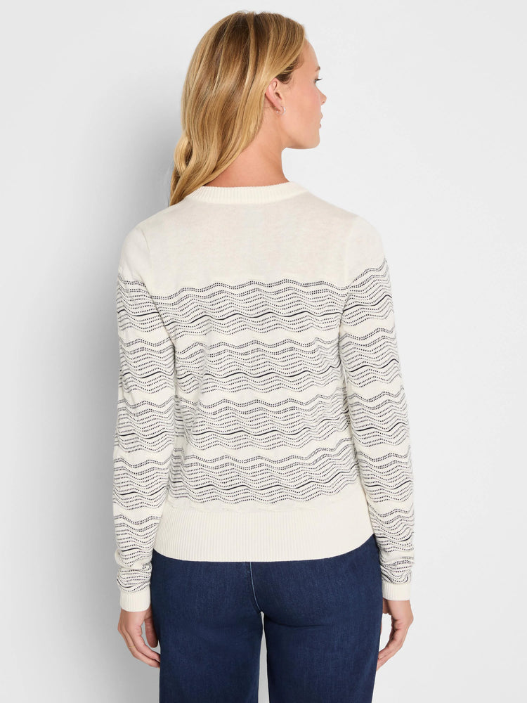 Off-white cardigan with black zig-zag patterns across body and sleeves.