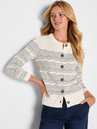 Cream cardigan with black zig-zag pattern, button-front, and ribbed trim.