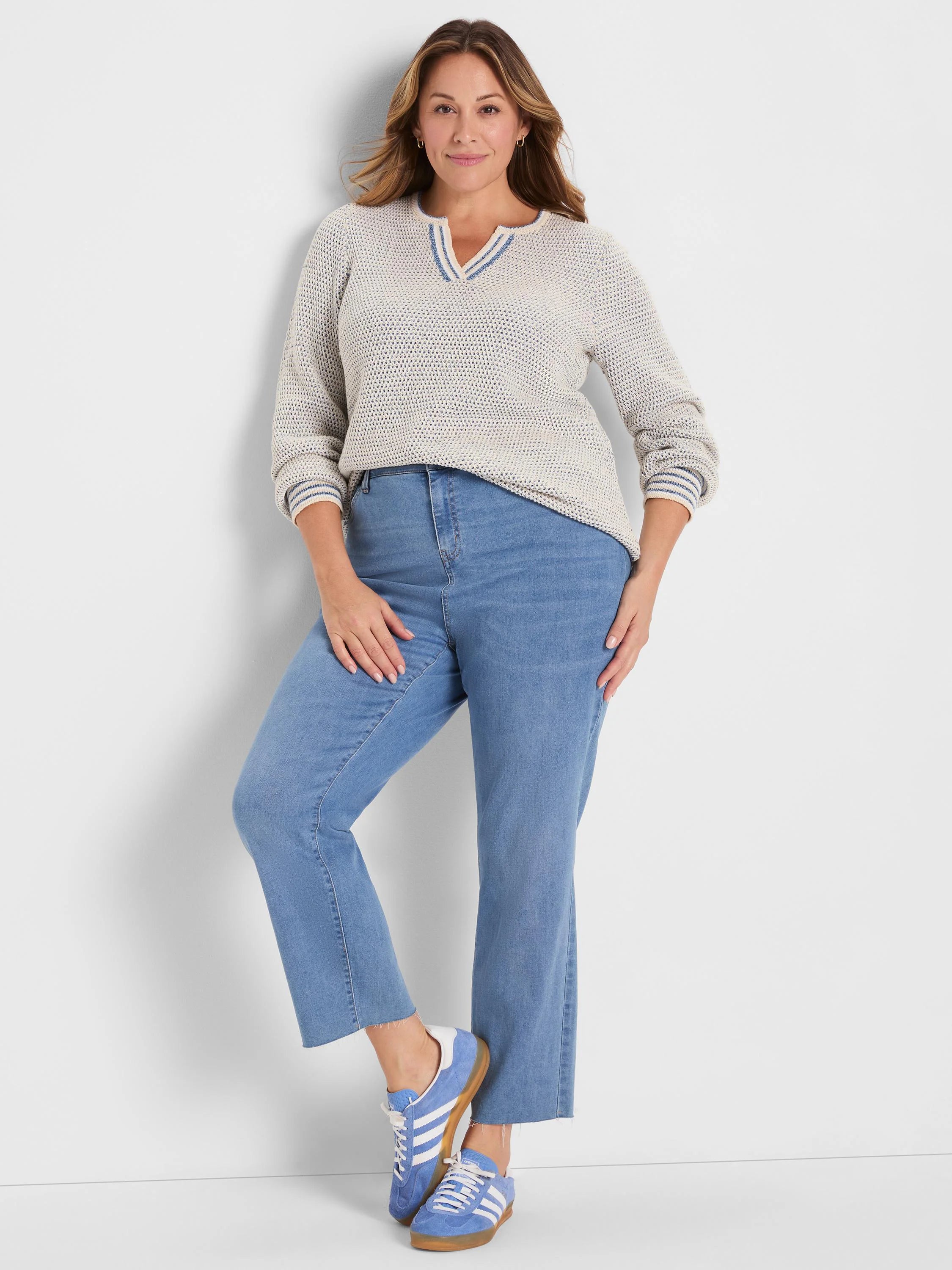 Off-white open-knit sweater with a blue-striped split neck and cuffs.