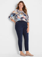 Long-sleeved sweater with abstract pattern in cream, navy, light blue, pink, and tan. Crew neck.