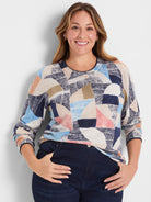Set Sail Sweater: Abstract geometric pattern in navy, light blue, cream, pink, and tan. Round neck, long sleeves.