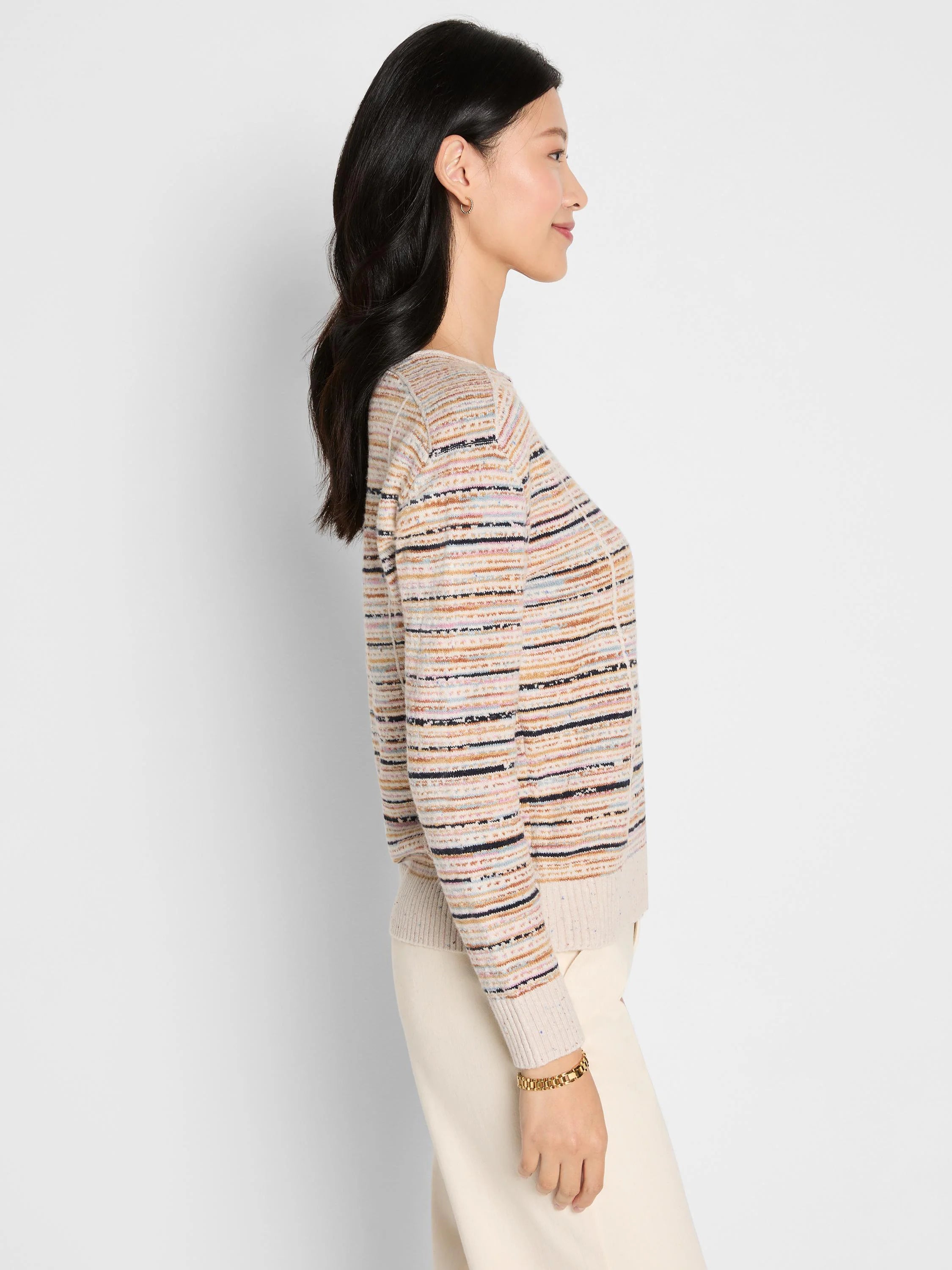 Muted multi-color striped sweater with horizontal bands of cream, beige, blue, pink, and black. Ribbed cuffs & hem.