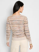 Cream-based sweater with thin multicolored stripes (pink, blue, brown, black). Distinct diagonal & vertical seams shape...