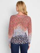 Regular fit long-sleeve knit top with a scoop neck and an abstract spotted pattern transitioning from warm terracotta to.