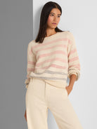 Relaxed cream open-knit pullover with long sleeves and pink horizontal stripes, featuring a crew neck and ribbed trim.