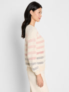 A relaxed cream open-knit sweater featuring pink and blue multi-color horizontal stripes, plus ribbed cuffs and hem.