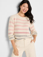 Relaxed cream open-knit sweater with multi-colored horizontal stripes, a crew neck, and cuffed three-quarter sleeves.