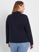 Dark navy fine knit bomber jacket with mock neck, modeled from behind.