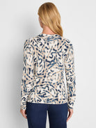 Cream, dark blue, and beige sweater with an abstract blurry leaf pattern.