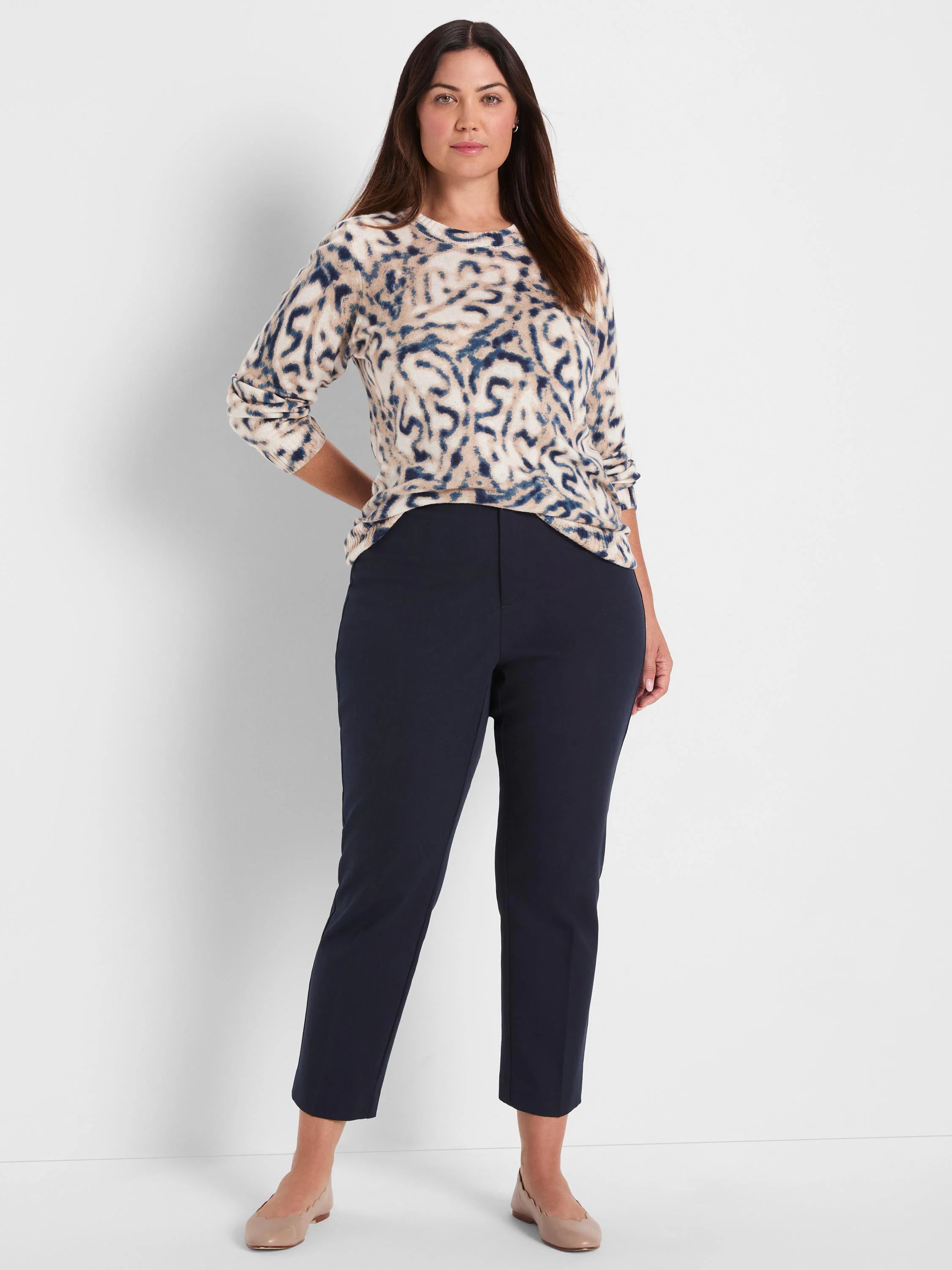 Cream crew neck sweater with abstract brown and navy blue blurry leaf pattern.