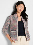 Tuck stitch jacket with navy, cream, red, and yellow woven pattern. Full-zip front and small buttoned pocket.