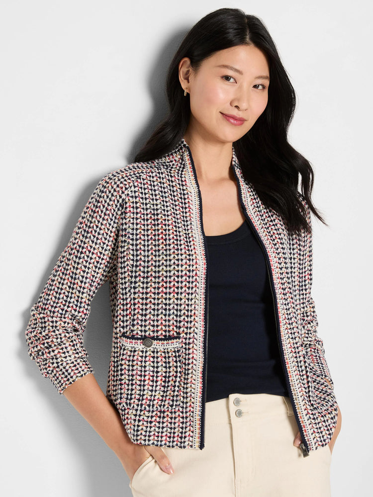 Tuck stitch jacket with navy, cream, red, and yellow woven pattern. Full-zip front and small buttoned pocket.