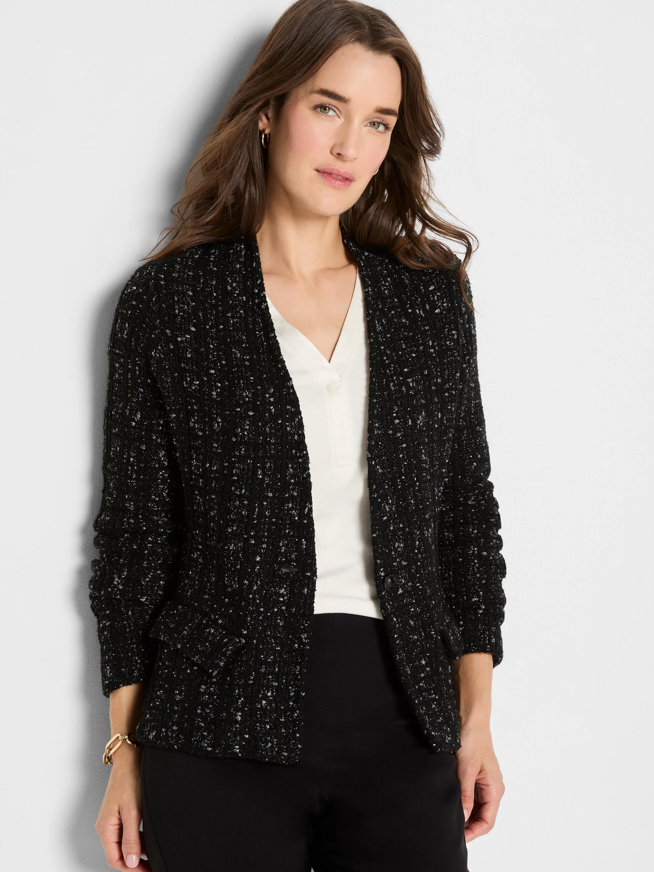 Black knit jacket with metallic silver flecks forming a textured grid. Worn open.