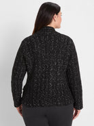 Black knit jacket with silver metallic threads forming a subtle grid pattern, seen from back.