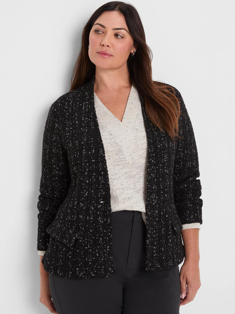 Black knit jacket with silver metallic threads, creating a grid-like texture. Open front, with pockets & gathered sleeves.