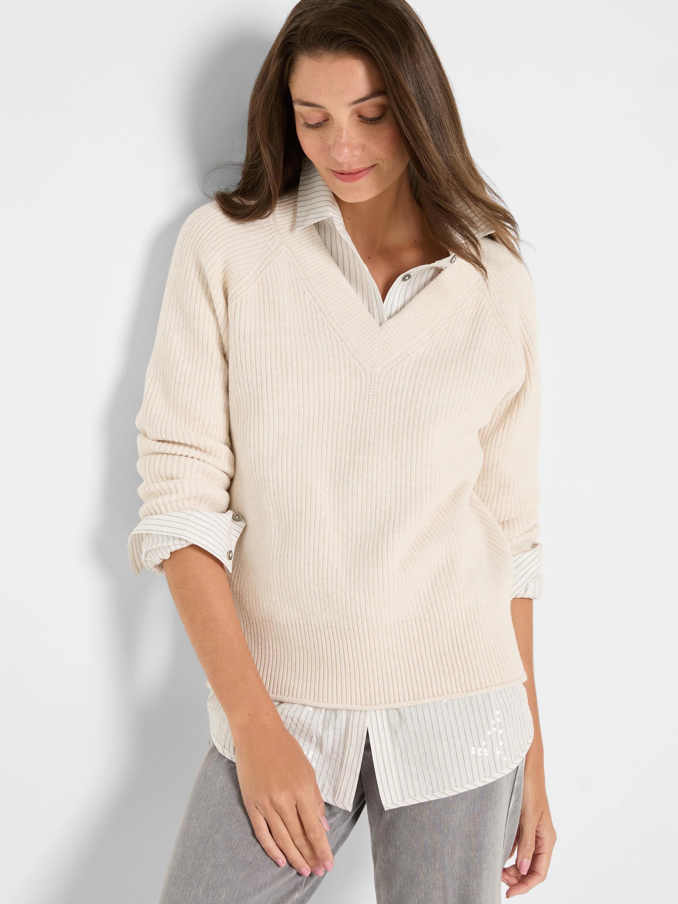 Cream V-neck shaker stitch sweater.