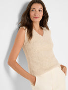 Cream sleeveless V-neck tank with a textured knit and subtle metallic flecks.