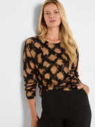 Long-sleeve sweater in a tan, black, and dark brown abstract check pattern with a round neck.