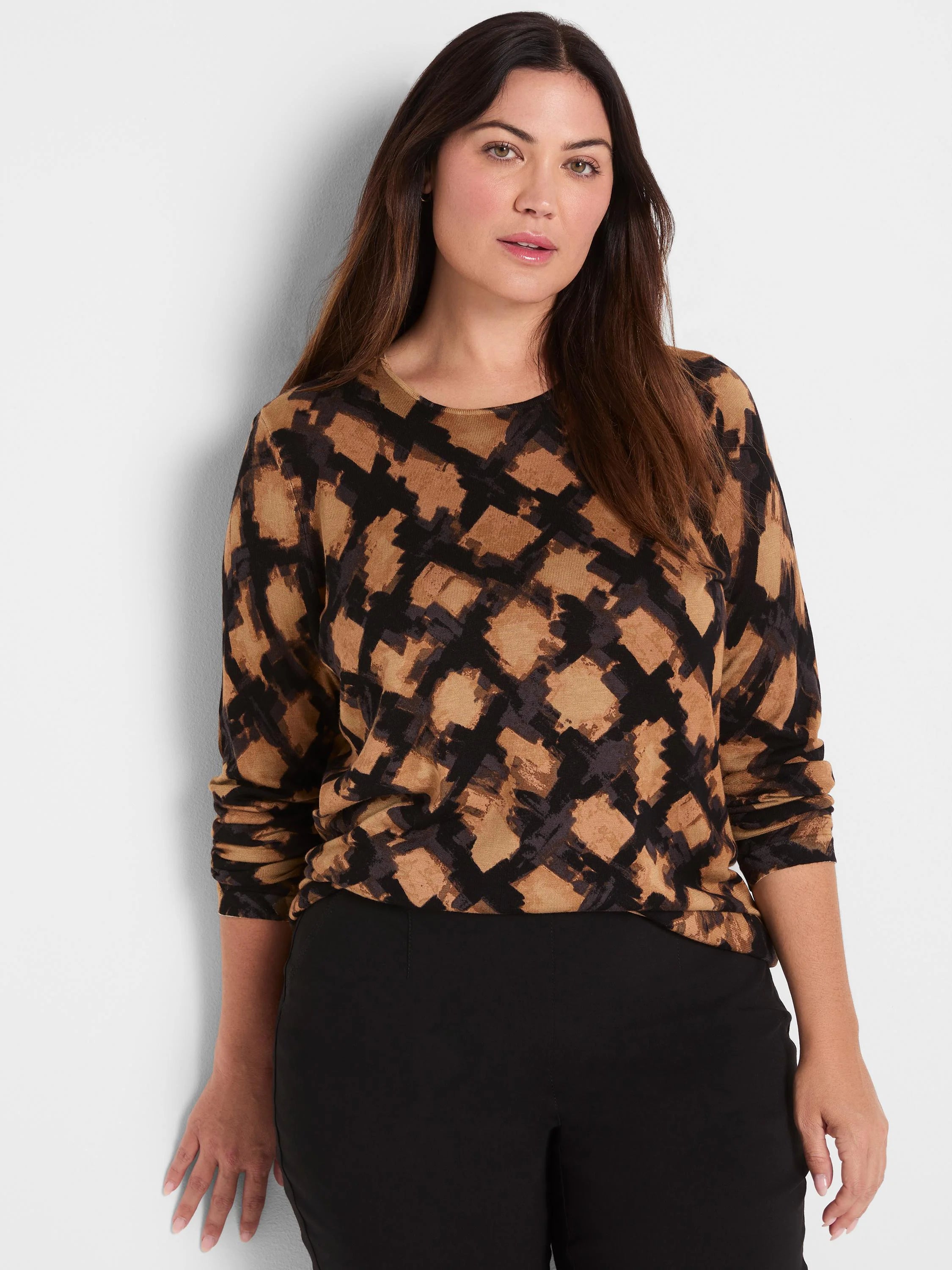 Brown, tan, and black sweater with a brushed, abstract check pattern and long sleeves.