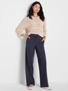 Light beige tape yarn stitch sweater with open knit chevron pattern.