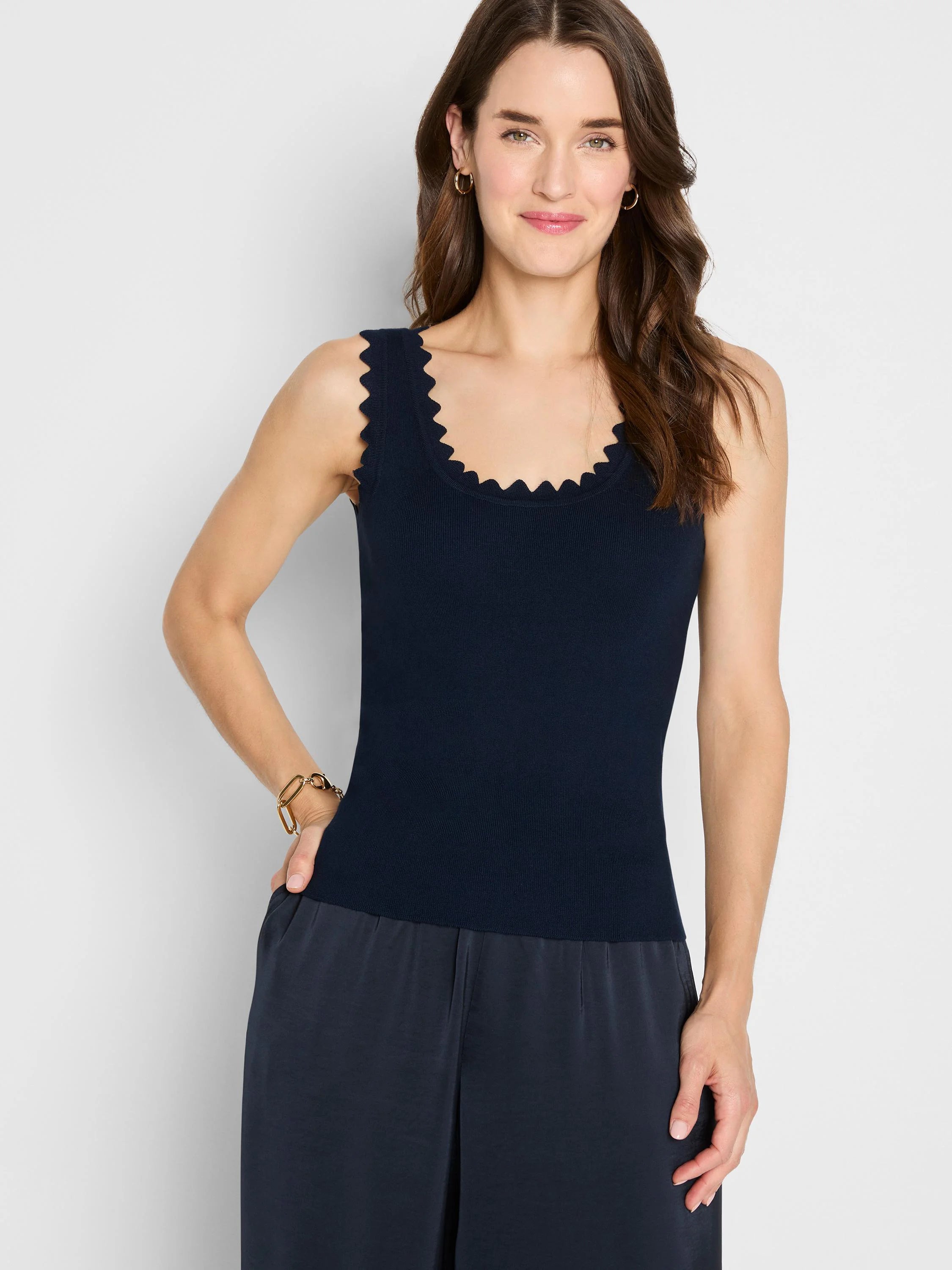 Fitted navy ribbed knit tank with scalloped edges at neckline and armholes.