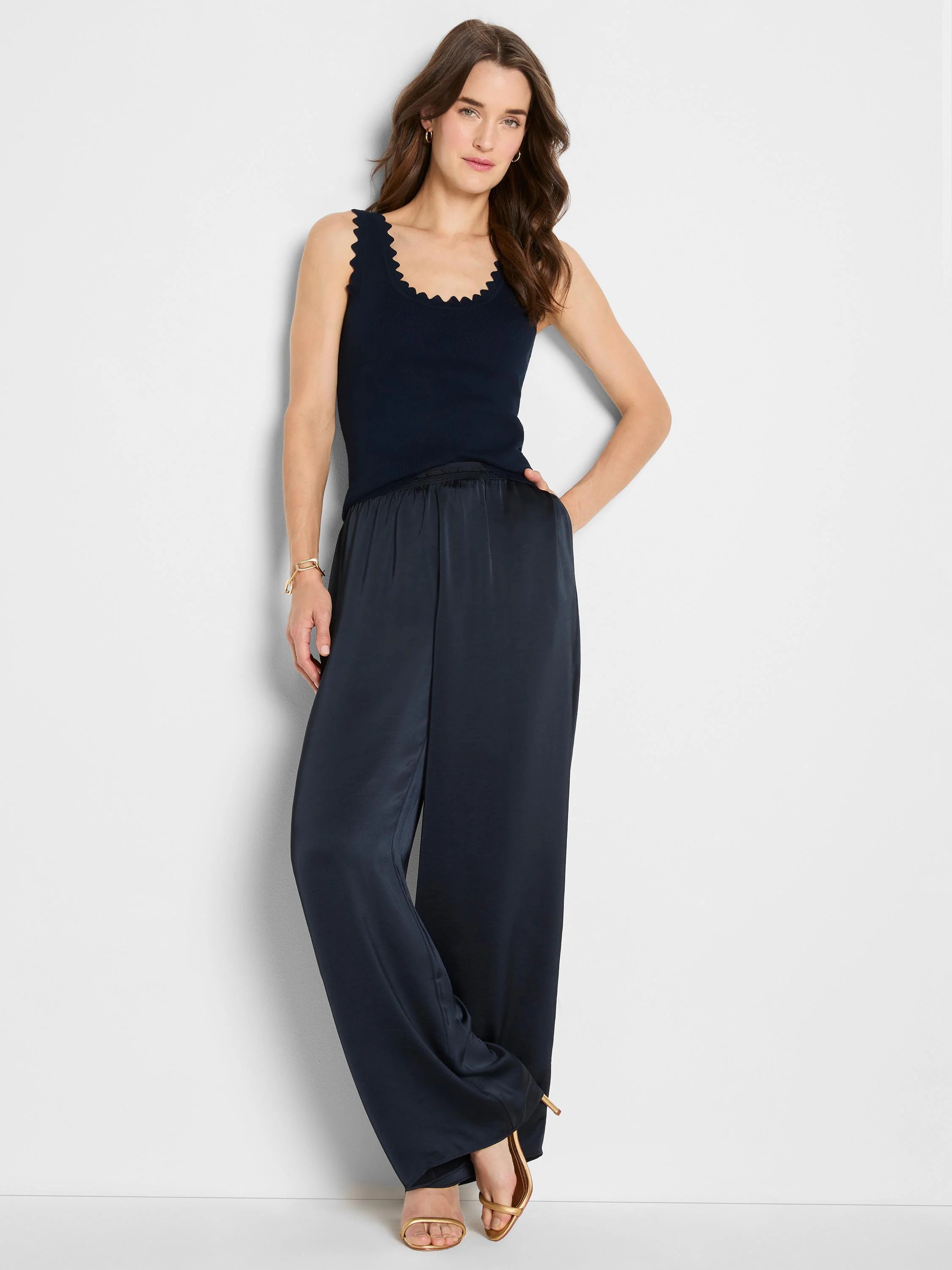 Navy blue ribbed sweater tank with scalloped neckline and armholes.