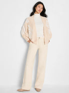 Light beige open-front cardigan with white floral embroidery on the sleeves and front.