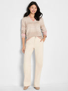 Beige striped V-neck sweater with pink trim on neck, sleeves, hem, and side lace-up details.