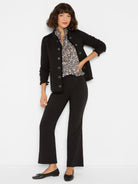 Black knit jacket with fringed collar, placket, and cuffs. Features silver-toned military buttons.