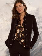 Dark knit jacket with fringe trim on edges and silver-toned buttons.
