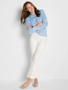 Light blue cotton cashmere sweater with textured knit, horizontal white dotted stripes, and ribbed cuffs/hem.