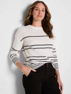 Cream textured knit sweater with black horizontal dotted stripes and striped cuffs/hem.